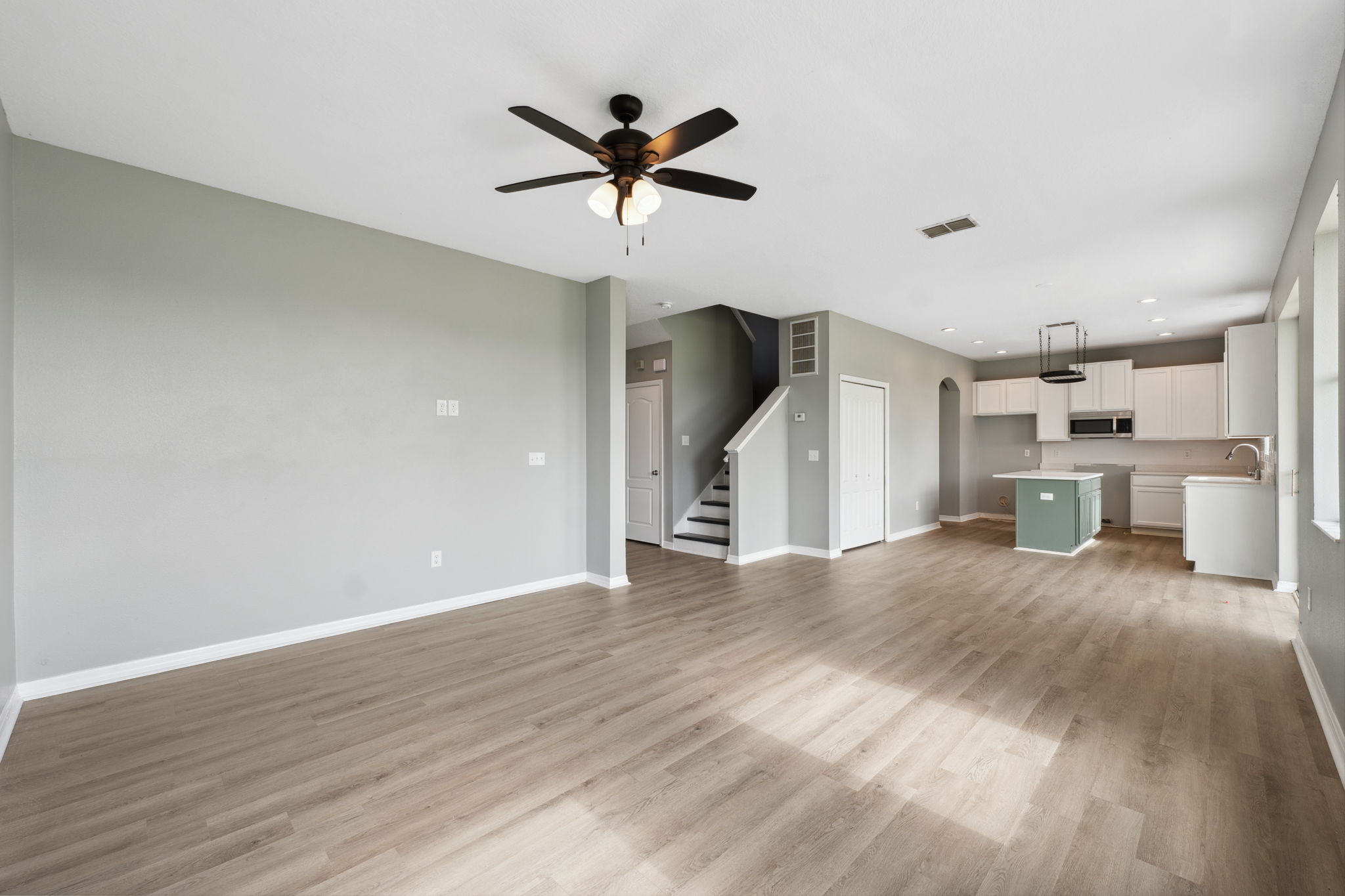 Empty living room and kitchen before virtual staging